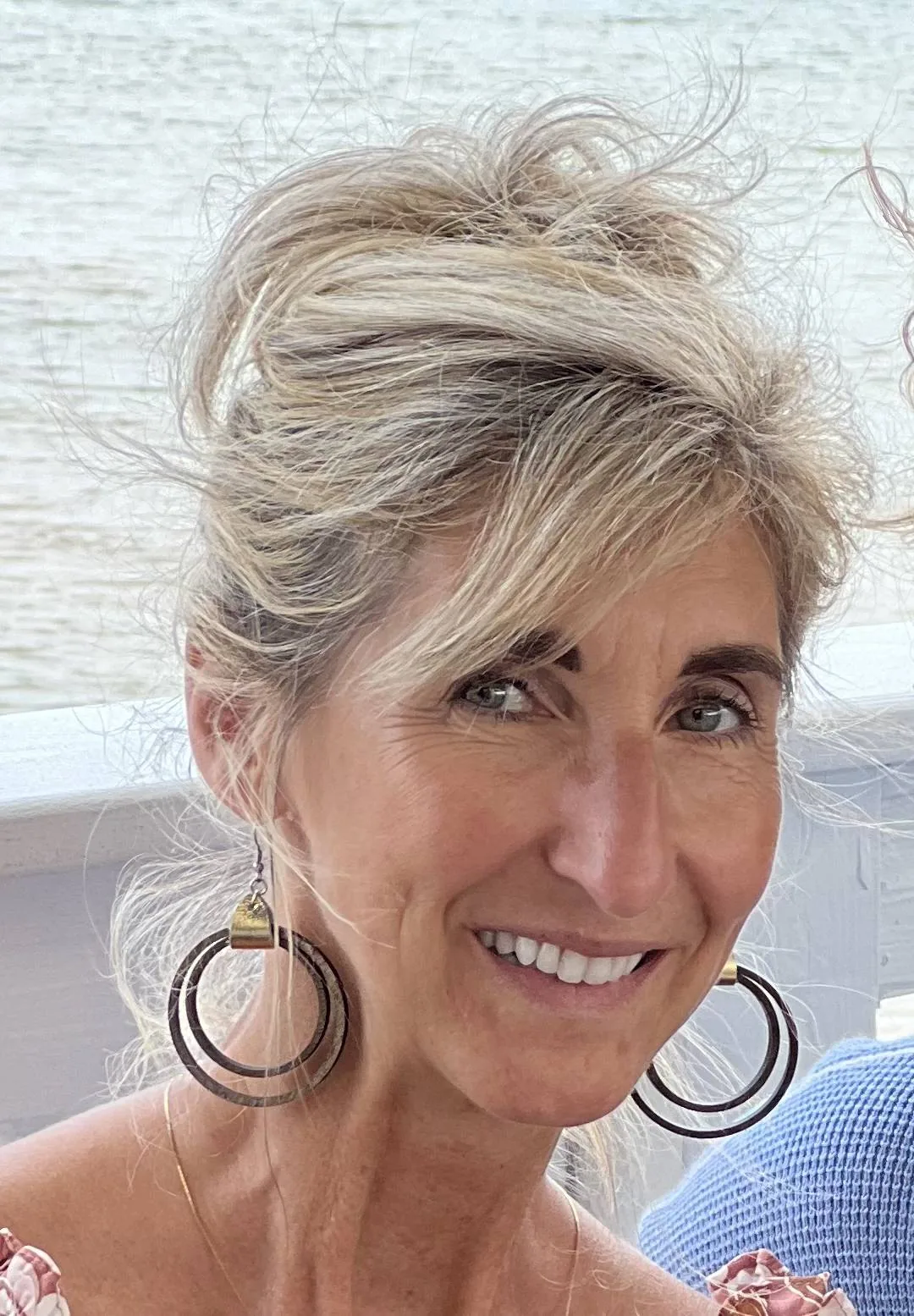 Theresa, the maker of Oola, smiling by the water
